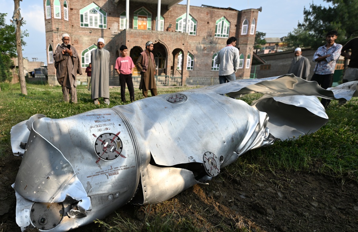 People watch an unclaimed part of an aircraft at Wuyan village in Pulwama district, about 20 km south of Srinagar city, the summer capital of Indian-controlled Kashmir, May 7, 2025. (Xinhua/Javed Dar)
