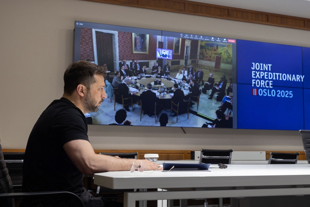 In this handout photograph taken and released by the Ukrainian Presidential Press Service on May 9, 2025, Ukraine's President Volodymyr Zelensky attends the annual Joint Expeditionary Force (JEF) Leaders' Summit, taking place in Oslo, via video link from his office in Kyiv. (Photo by Handout / AFP) 