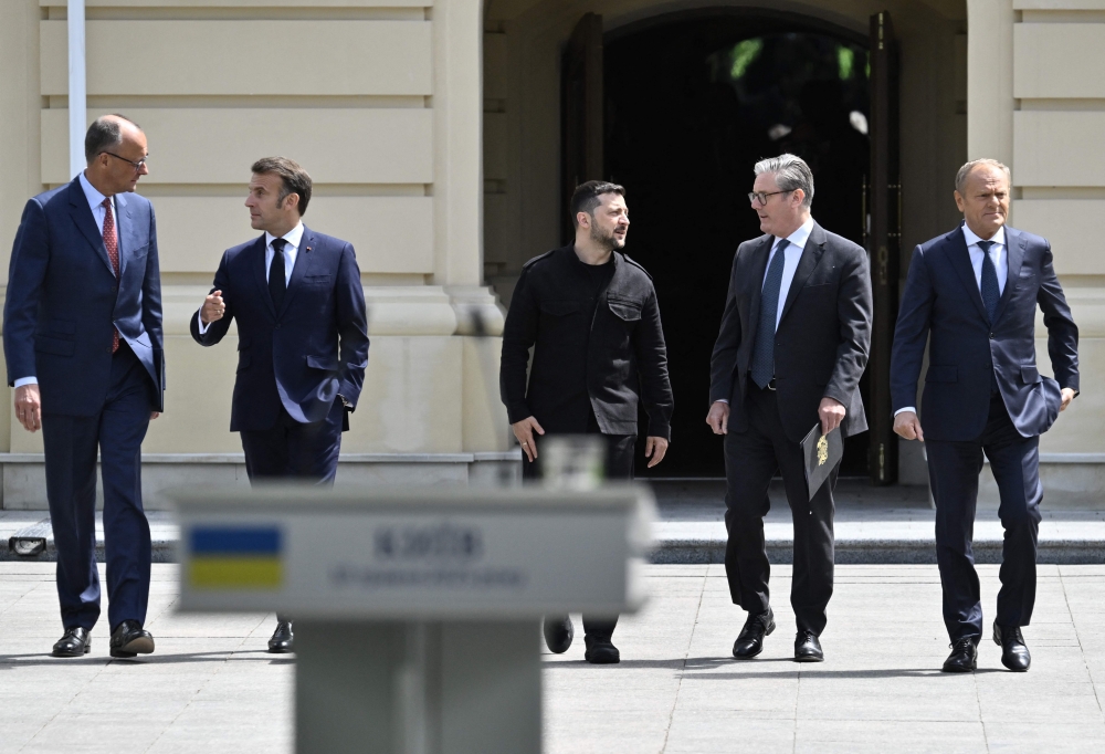 (From Left) Germany's Chancellor Friedrich Merz, France's President Emmanuel Macron, Ukraine's President Volodymyr Zelensky, Britain's Prime Minister Keir Starmer and Poland's Prime Minister Donald Tusk arrive to a press conference after their meeting in the capital Kyiv on May 10, 2025. (Photo by Genya Savilov / AFP)