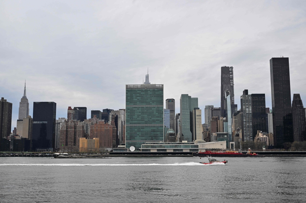 A boat on the East River passes United Nations Headquarters on April 10, 2025 in New York. (Photo by Angela Weiss / AFP)