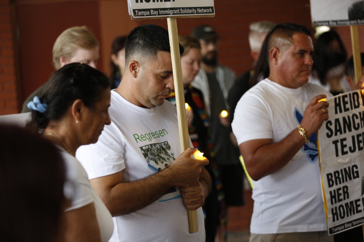 Carlos Valle (C), husband of Heidy Sanchez attends a vigil in support of Sanchez and to honor all mothers who have been separated form their children because of deportations at Centennial Park in Tampa, Florida, on May 10, 2025. (Photo by OCTAVIO JONES / AFP)
