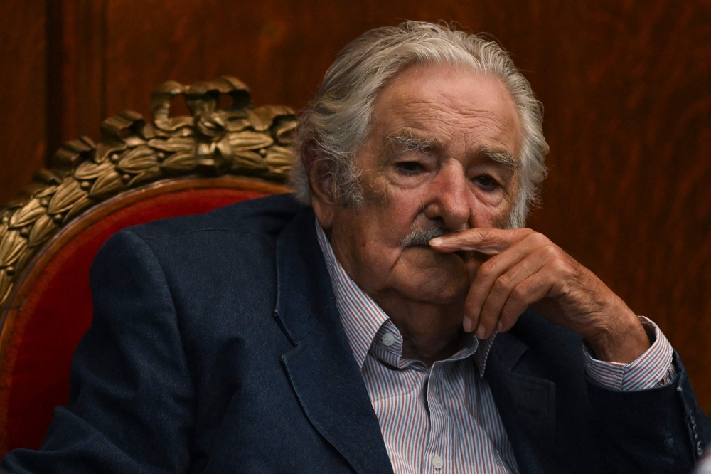 (FILES) Uruguayan former President Jose Mujica gestures during a ceremony where he was honored for his contribution to the Colombian peace process in Montevideo on February 16, 2023. (Photo by Pablo PORCIUNCULA / AFP)