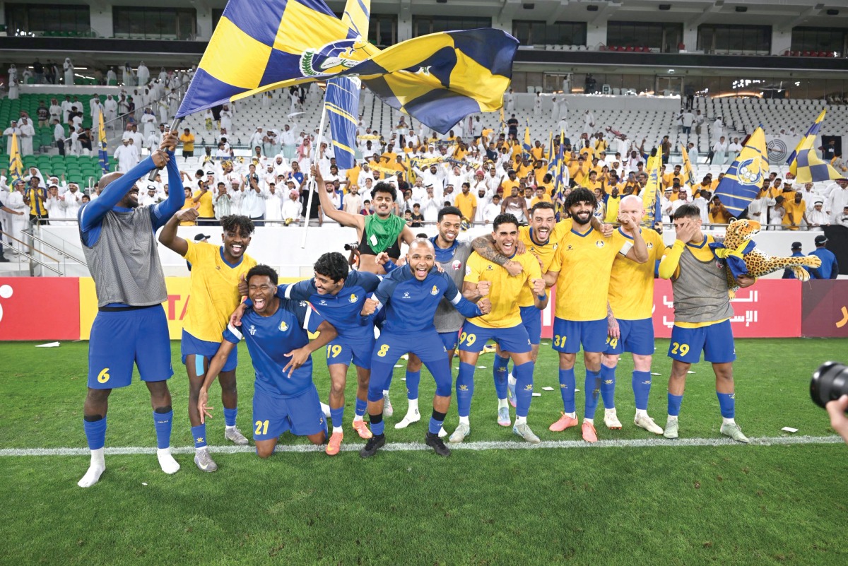 Al Gharafa players celebrate after defeating Al Sadd.