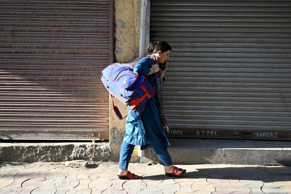 Shruti Sharma who had fled her border home in Kashmir's Poonch, returns on May 14, 2025. Photo by Money SHARMA / AFP.
