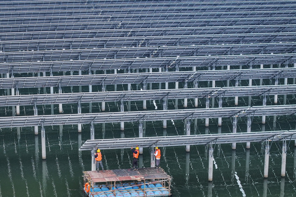 Photo used for representational purposes. Workers install solar panels at the fishing-solar complementary photovoltaic power generation base in Rudong, in eastern China's Jiangsu province on May 14, 2025. Photo by AFP.