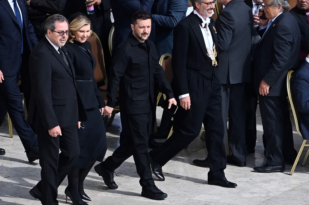 Ukraine's President Volodymyr Zelensky (2ndR) and his wife Elena arrive to attend a Holy Mass for the Beginning of the Pontificate of Pope Leo XIV, in St Peter's square in The Vatican on May 18, 2025. (Photo by Isabella Bonotto / AFP)