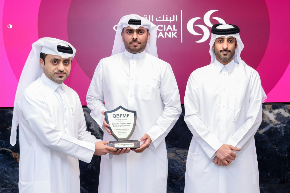 Officials pose for a group photo with the award.