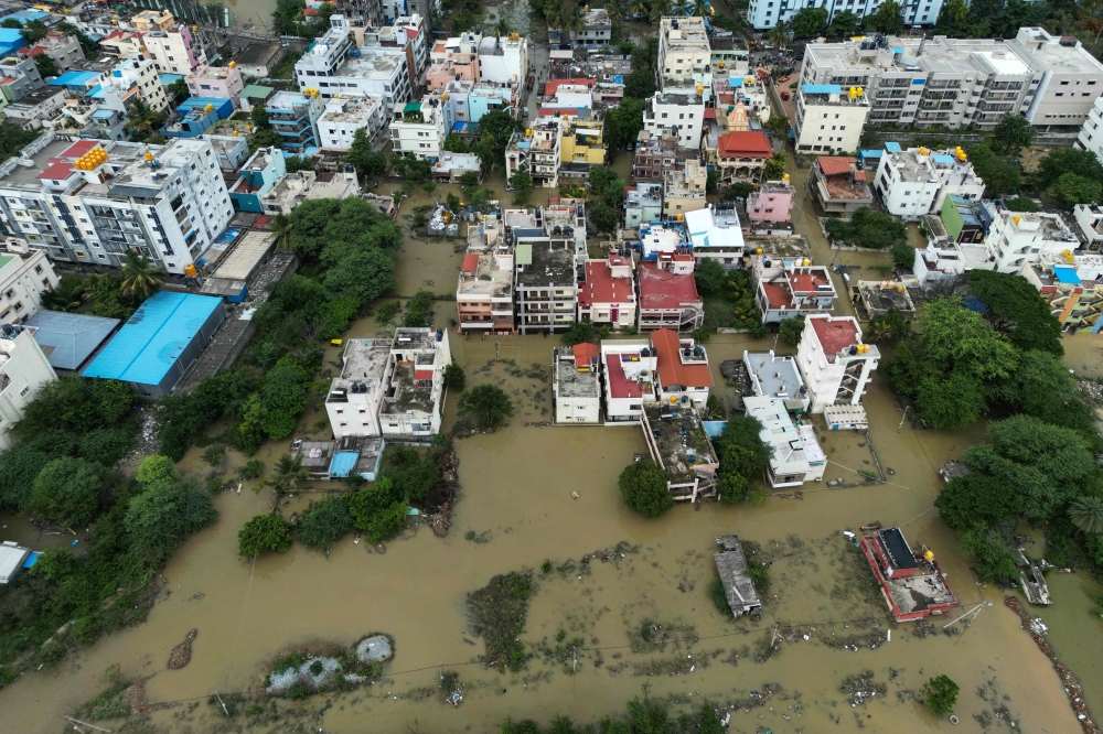 An aerial view shows a flooded locality following heavy rainfall in Bengaluru on May 19, 2025. (Photos by Idrees Mohammed / AFP)
