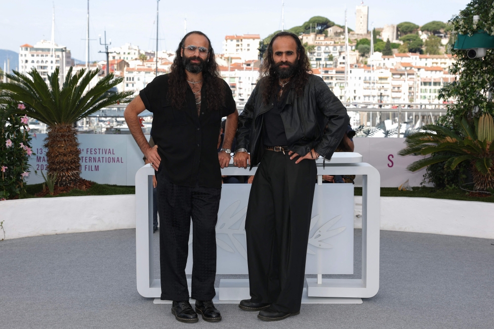 Palestinian director and screenwriter Tarzan Nasser and Palestinian director and screenwriter Arab Nasser pose during a photocall for the film 