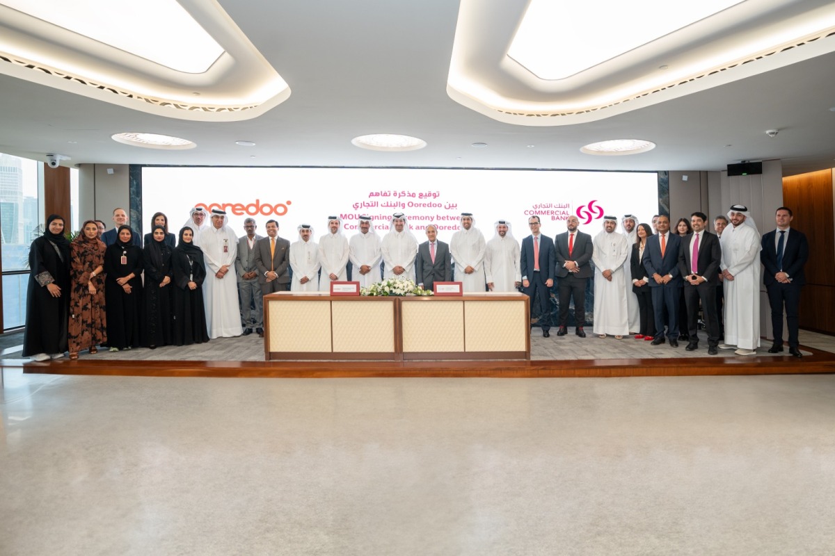 Commercial Bank and Ooredoo officials during the agreement signing.