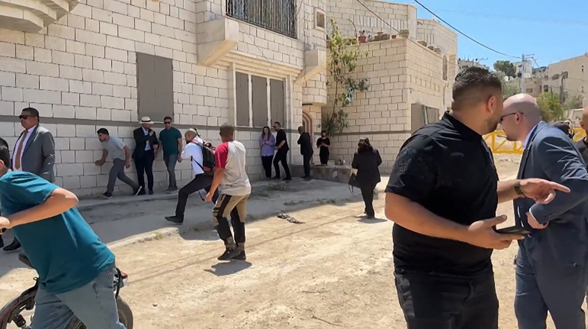 This frame grab from AFPTV footage shows members of a diplomatic delegation from the European Union reacting after shots were fired as they gathered in the eastern entrance of Jenin camp during a visit to the city of Jenin, on May 21, 2025, amid an ongoing Israeli military offensive in the occupied West Bank. Photo by Mohammad Ateeq / AFPTV / AFP.