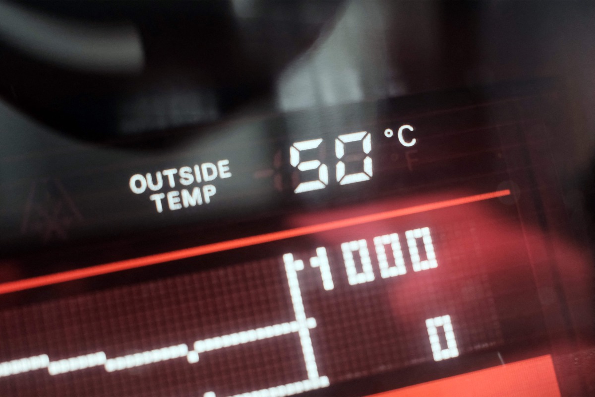 A dashboard display shows an external temperatue of 50 degrees celsius outside a vehicle in Dubai on May 23, 2025. (Photo by Giuseppe CACACE / AFP)