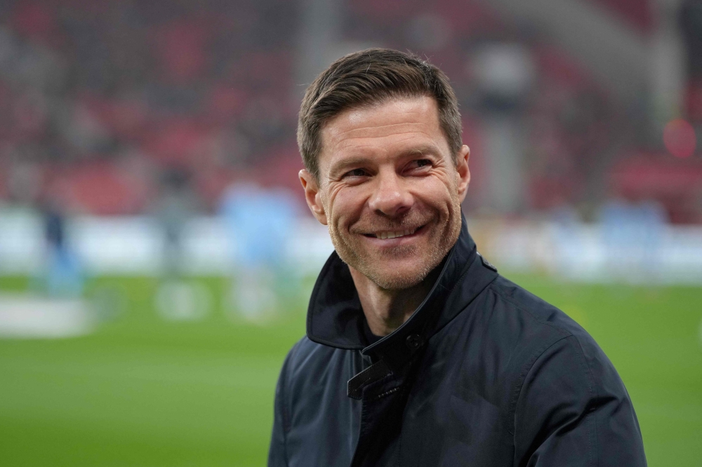 (Files) Bayer Leverkusen's Spanish head coach Xabi Alonso arrives prior to the German first division Bundesliga football match on March 28, 2025. (Photo by Pau Barrena / AFP) /