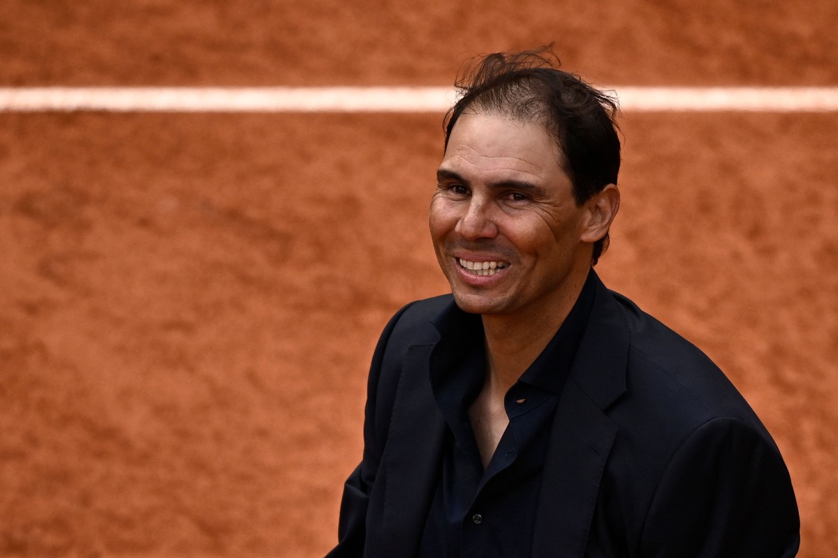 Former Spanish player Rafael Nadal smiles during a ceremony honoring his career on Court Philippe-Chatrier as part of the French Open tennis tournament at the Roland-Garros Complex in Paris on May 25, 2025. (Photo by JULIEN DE ROSA / AFP)
