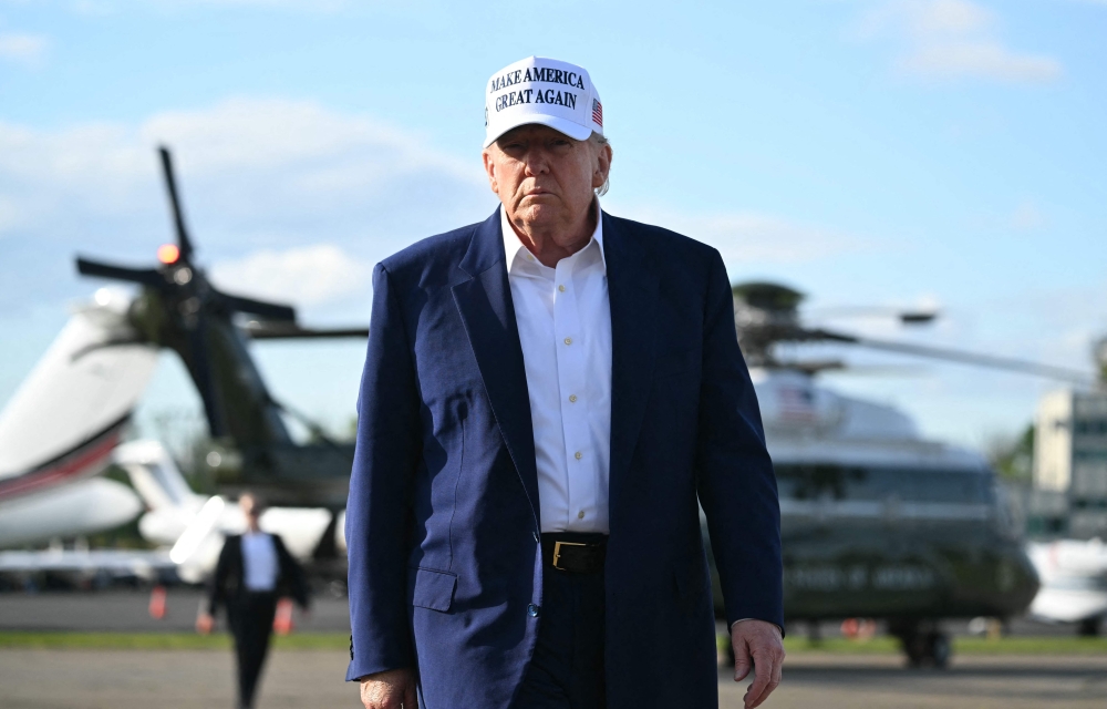 US President Donald Trump walks to speak to journalists before boarding Air Force One from Morristown Municipal Airport in Morristown, New Jersey, May 25, 2025, after spending the weekend in New Jersey. (Photo by Saul Loeb / AFP)