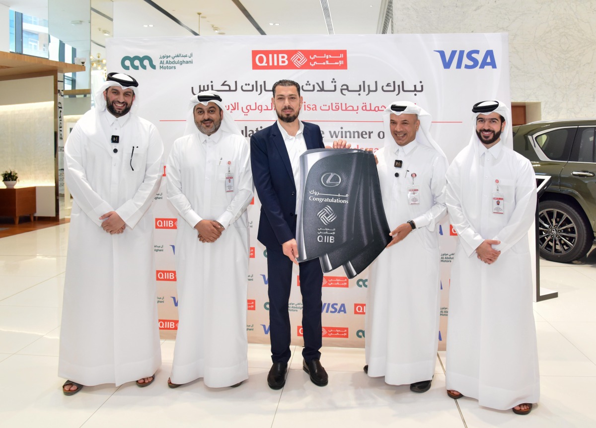 QIIB Chief of Human Resources and Administration, Ali Hamad Al-Mesaifri, and other officials presenting keys of three lexus vehicles to the winner.
