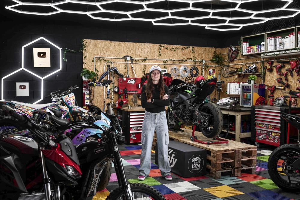 French world champion stuntwoman, Sarah Lezito, poses for portraits with her motorbikes in her garage near Epernay eastern France, on May 22, 2025. (Photo by Thibaud Moritz / AFP)
 