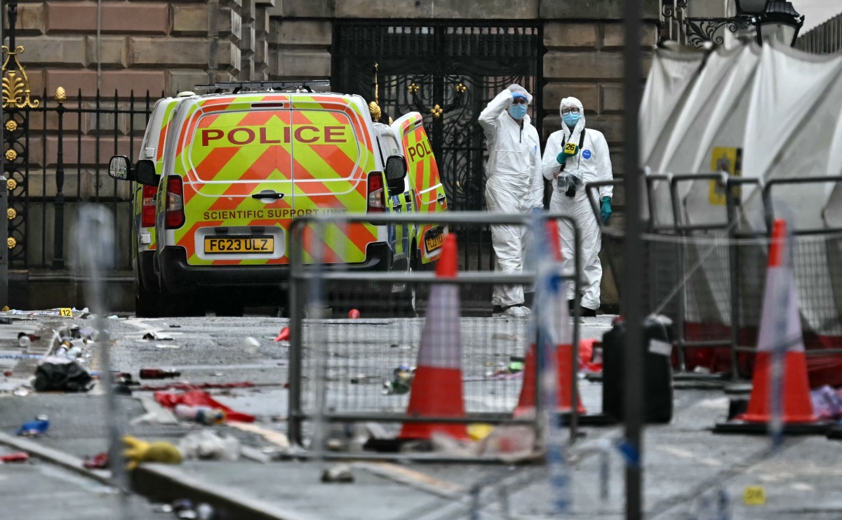 Police forensics officers work at the scene on Water Street in Liverpool, north-west England on May 27, 2025. ( (Photo by Paul ELLIS / AFP)