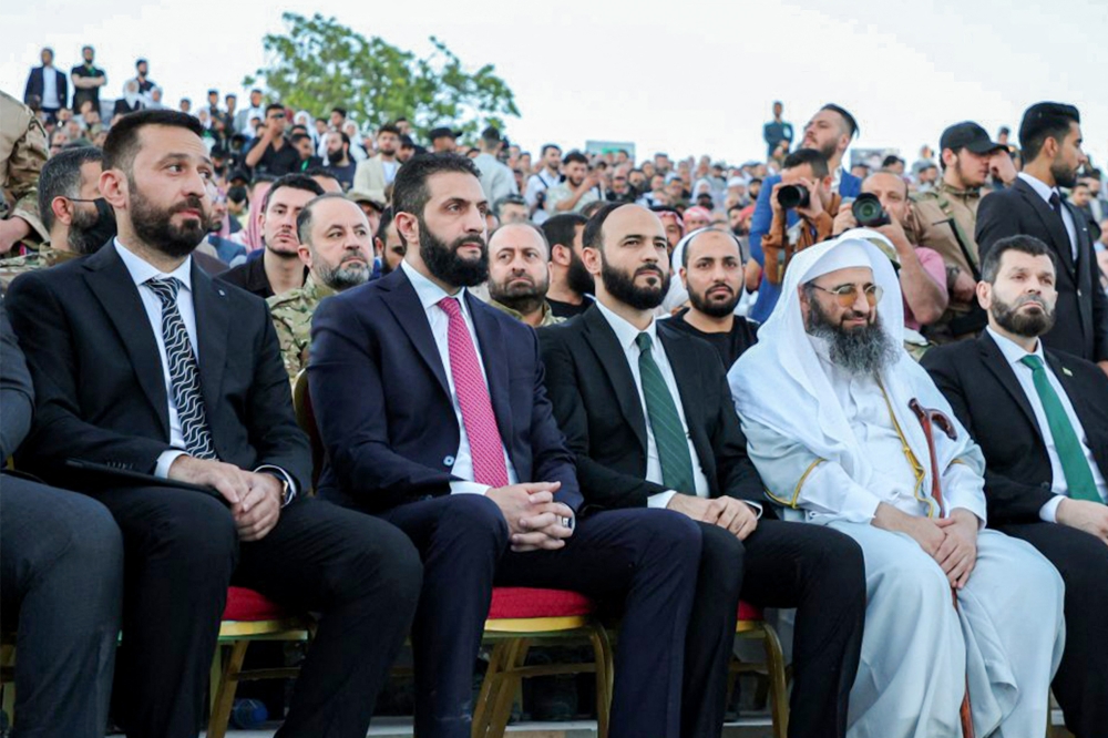 This handout picture shows Syria's interim president Ahmed Al Sharaa (2nd left) attending an event at the Aleppo Citadel on May 27, 2025. (Photo by SANA / AFP)
