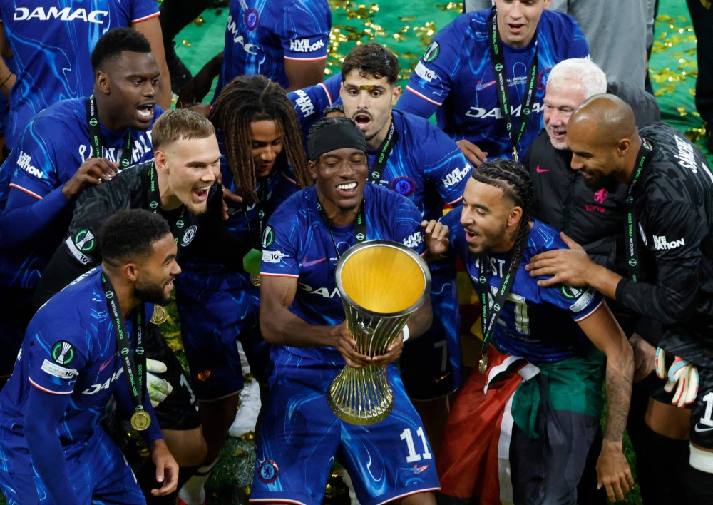 Chelsea's English midfielder #11 Noni Madueke holds the trophy after the UEFA Conference League final football match between Real Betis and Chelsea FC in Wroclaw on May 28, 2025. (Photo by Wojtek Radwanski / AFP)