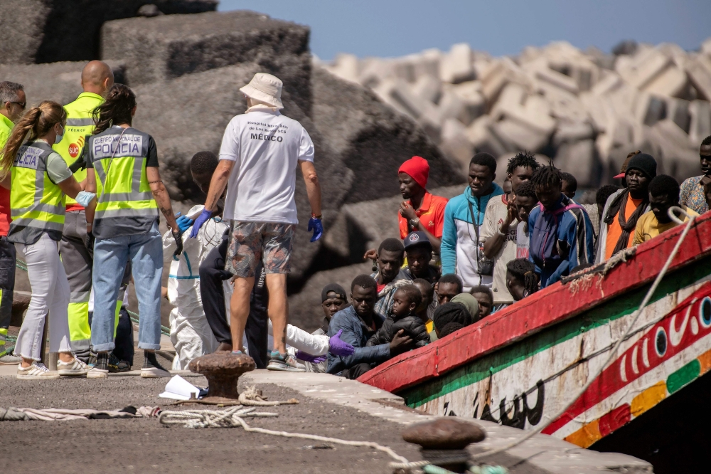 File photo: Members of police forces and emergency services help 175 migrant people on board a boat, upon its arrival at Restinga port on the Canary island of El Hierro on August 18, 2024. (Photo by Antonio Sempere / AFP)
