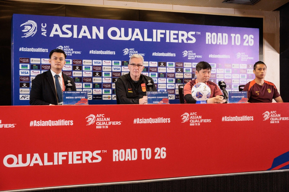 China's Croatian head coach Branko Ivankovic (2nd L) and China's Zhang Yuning (R) attend a press conference ahead of the FIFA World Cup 2026 Asia zone qualifiers group C football match between Indonesia and China at Gelora Bung Karno Stadium in Jakarta on June 4, 2025. (Photo by YASUYOSHI CHIBA / AFP)