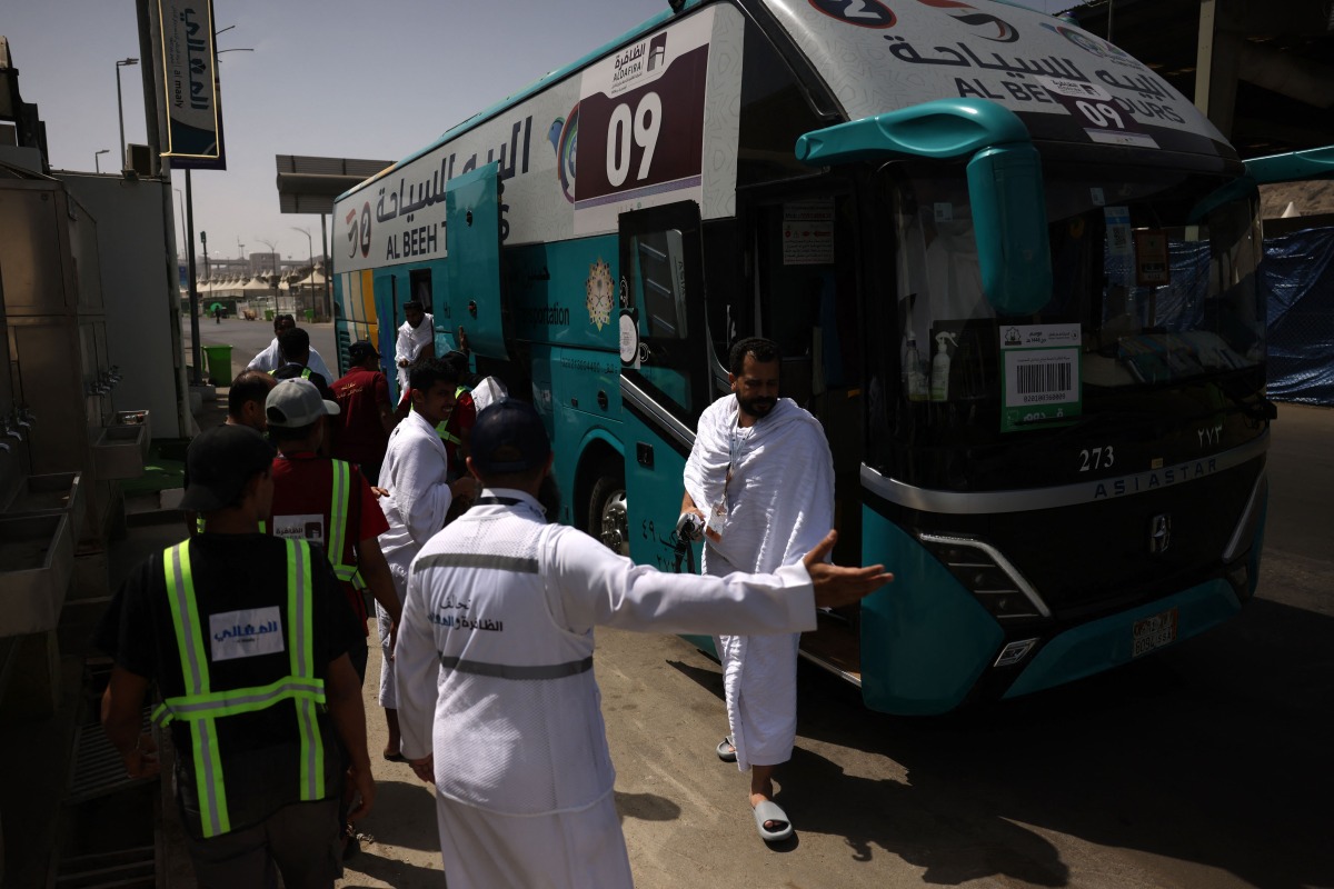 Muslim pilgrims disembark a bus in Mina near Islam's holy city of Mecca on June 3, 2025, ahead of the annual Hajj pilgrimage. (Photo by HAZEM BADER / AFP)

