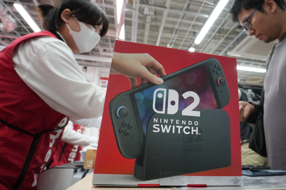 A customers purchases Nintendo Switch 2 at an electronics retailer in Tokyo on June 5, 2025. (Photo by Kazuhiro Nogi / AFP)