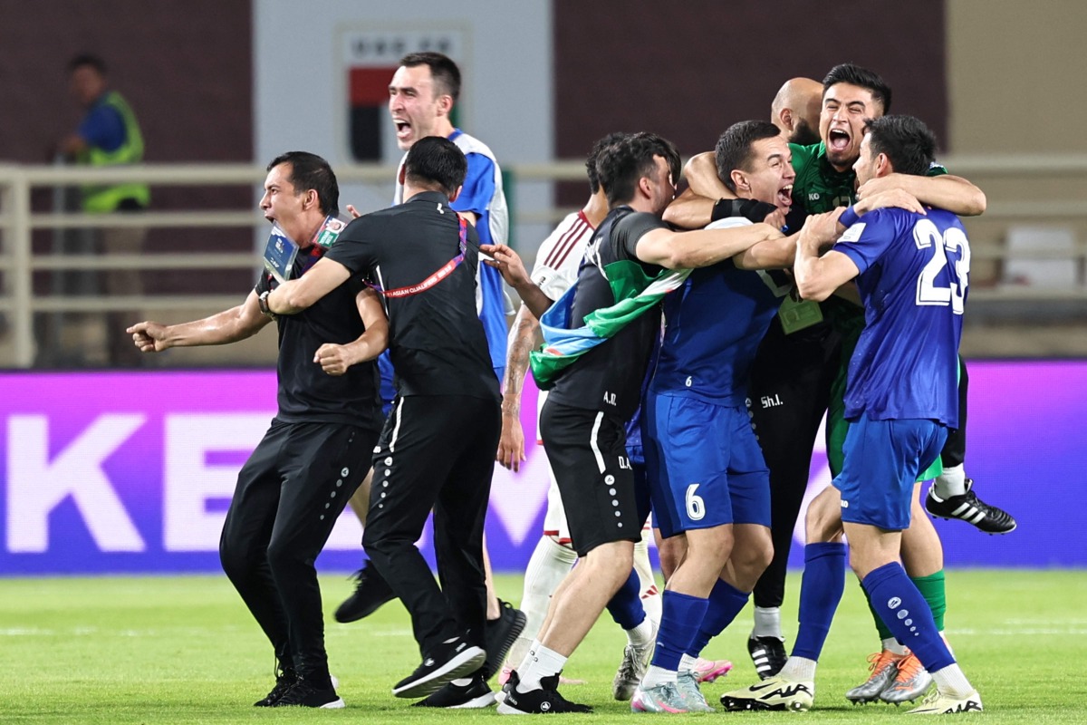 Uzbekistan's players celebrate after their 2026 FIFA World Cup Asian Qualifier football match against the United Arab Emirates ended in a draw, qualifying them for the World Cup for the first time, at Al-Nahyan Stadium in Abu Dhabi on June 5, 2025. (Photo by Fadel SENNA / AFP)

