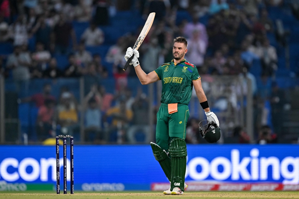 South Africa's Aiden Markram celebrates after scoring a century (100 runs) during the 2023 ICC Men's Cricket World Cup one-day international (ODI) match between South Africa and Sri Lanka on October 7, 2023. (Photo by Sajjad Hussain / AFP)