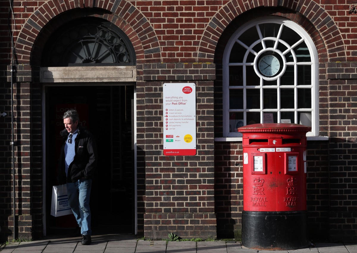 A customer exits a branch of Post Office in Swindon, western England on January 22, 2024. Photo by Adrian DENNIS / AFP