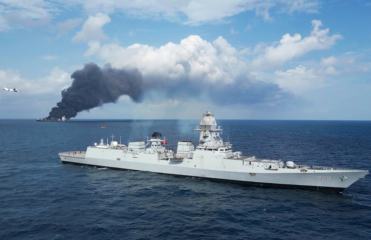 This handout photograph taken and released on June 9, 2025 by the Indian Navy shows smoke billowing from a cargo vessel that caught fire off Beypore coast in India's Kerala state. (Photo by INDIAN NAVY / AFP)