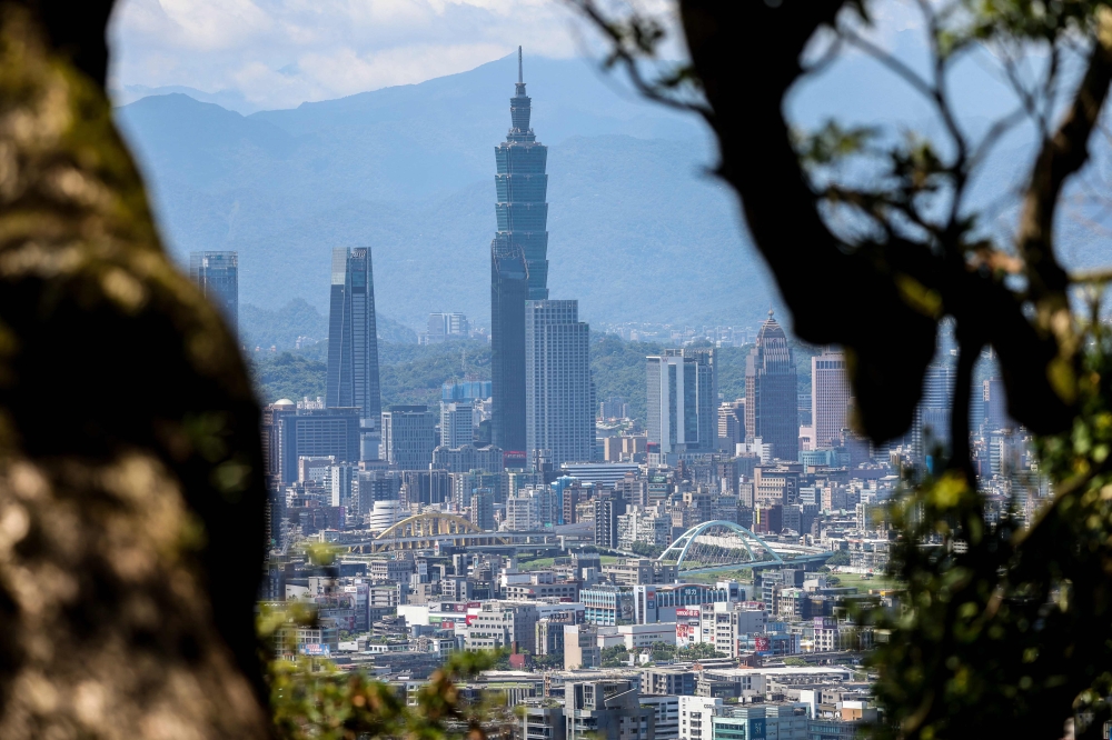 The Taipei 101 building stands among residential and commercial buildings in Taipei on June 10, 2025. (Photo by I-Hwa Cheng / AFP)