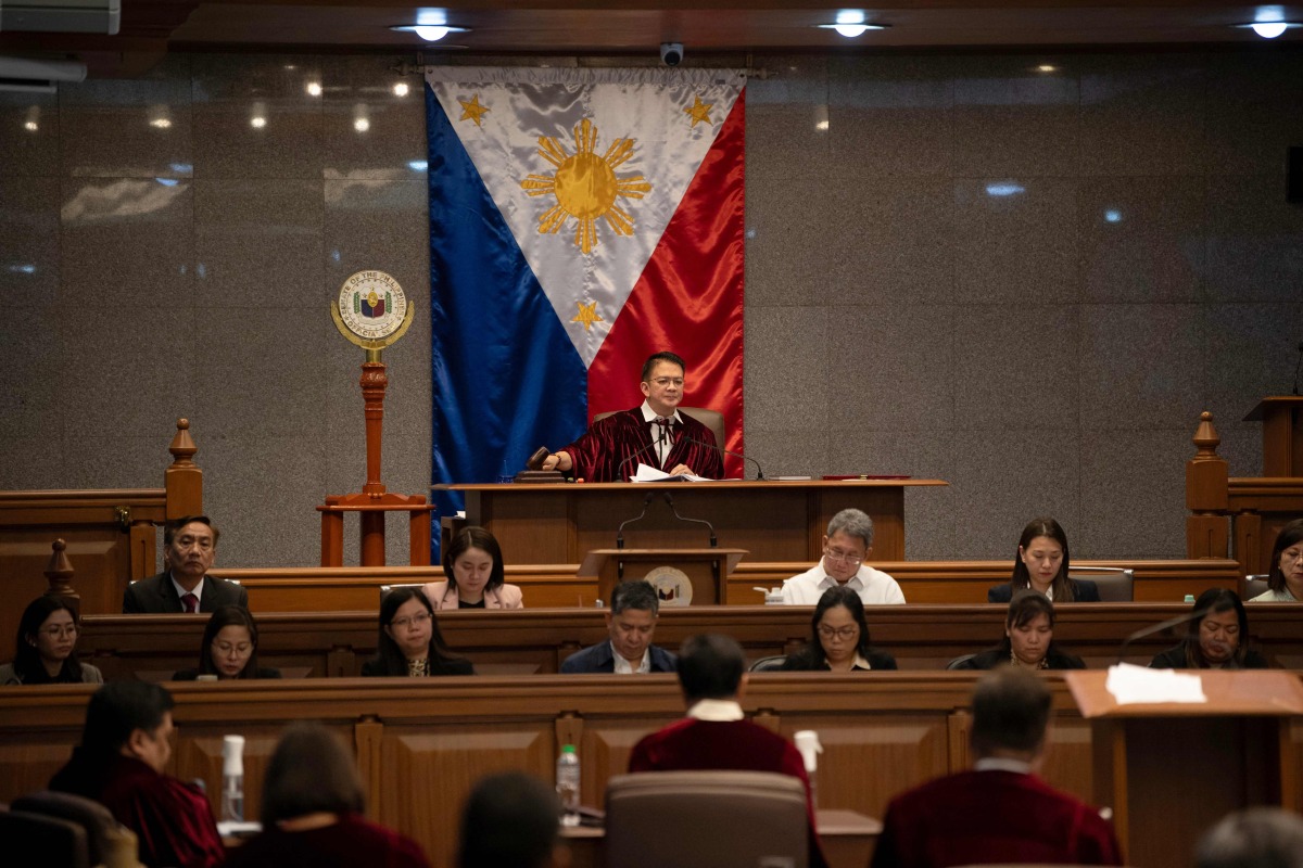 Philippine Senate president Francis Escudero bang the gavel after philippine senators took their oath as jurors in the impeachment trial of Vice President Sara Duterte, with the newly convened court moving to immediately hear a motion to dismiss the case, in Manila on June 10, 2025. (Photo by Ted ALJIBE / AFP)
