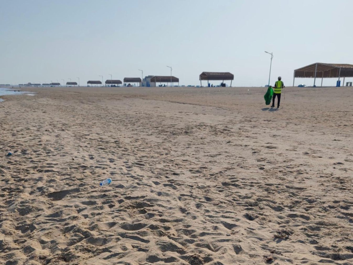 One of the participants clearing the beach of garbage.
