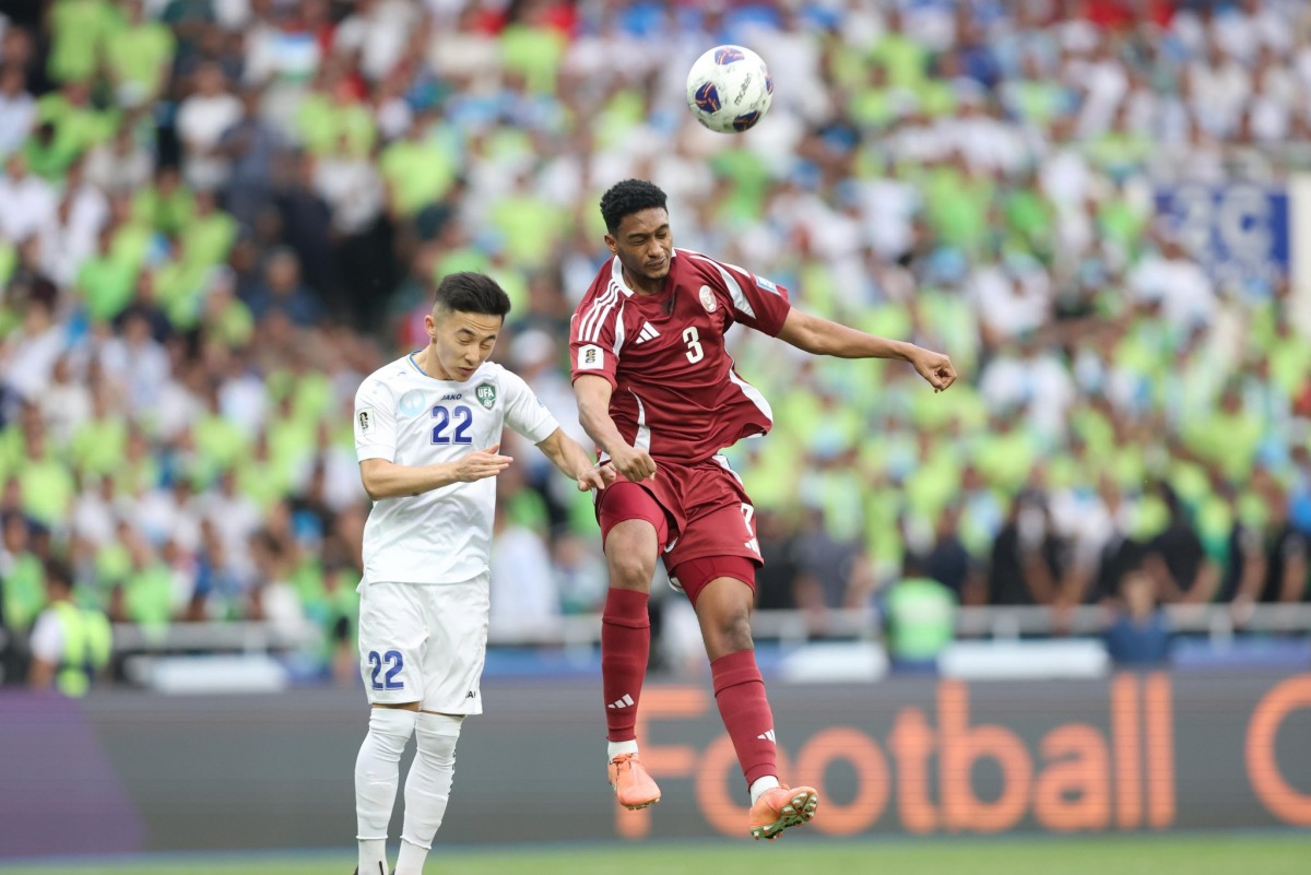 Qatar defender Abdullah Youssef (right) vies for the ball with Uzbekistan’s Abbosbek Fayzullaev.
