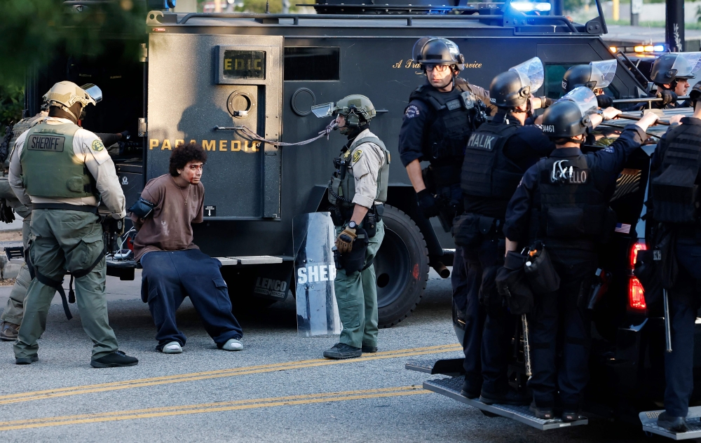 A detained person is treated for an injury as police detain protesters near City Hall as demonstrations continue after a series of immigration raids began last Friday on June 11, 2025 in Los Angeles, California. Mario Tama/Getty Images/AFP 