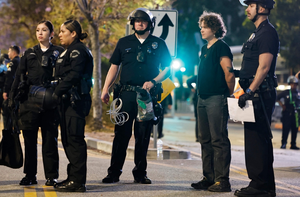 LAPD officers detain protesters near City Hall as demonstrations continue after a series of immigration raids began on June 11, 2025 in Los Angeles, California. Mario Tama/Getty Images/AFP 