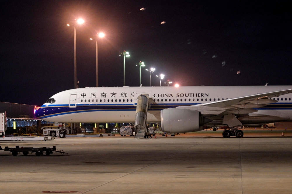 An Airbus A350-900 aircraft of China is parked at Shanghai Hongqiao International Airport in Shanghai, June 12, 2025. (Photo by Hector Retamal / AFP)