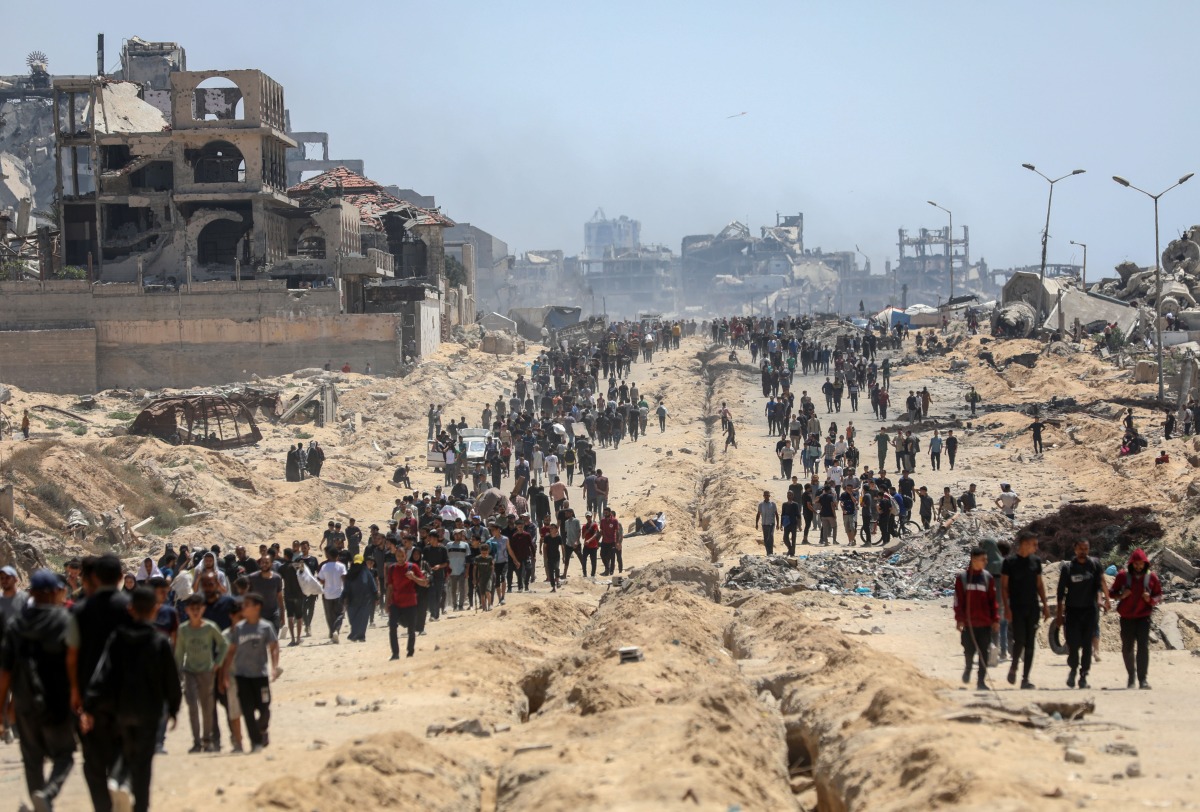 Palestinians are seen in the Sudaniya area, northern Gaza City, on June 12, 2025. (Photo by Rizek Abdeljawad/Xinhua)
