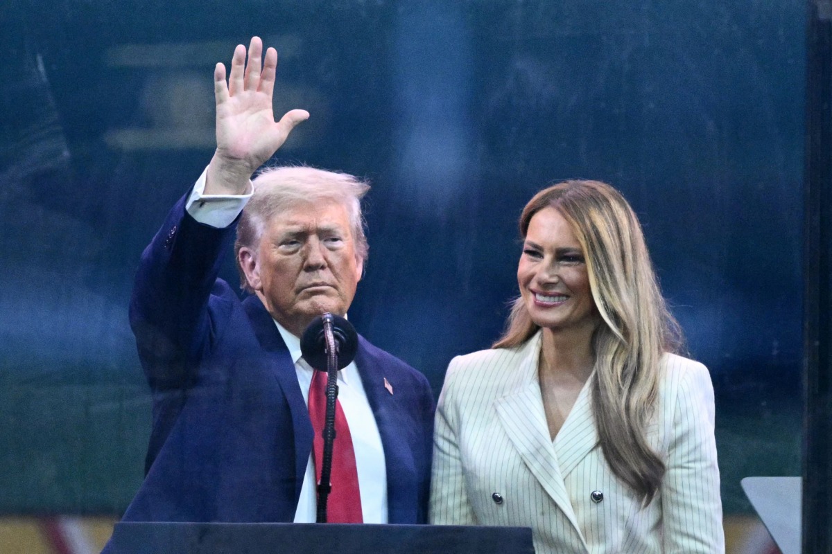 US President Donald Trump (L) waves next to US First Lady Melania Trump after the Army 250th Anniversary Parade in Washington, DC on June 14, 2025. Photo by Mandel NGAN / AFP.