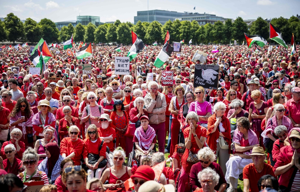Protestors wave Palestinian flags and signs as they attend a demonstration called by Oxfam Novib, PAX, Amnesty International, Save the Children and Doctors Without Borders in support for the Palestinians, in The Hague on June 15, 2025. (Photo by ANP KOEN VAN WEEL / ANP / AFP)