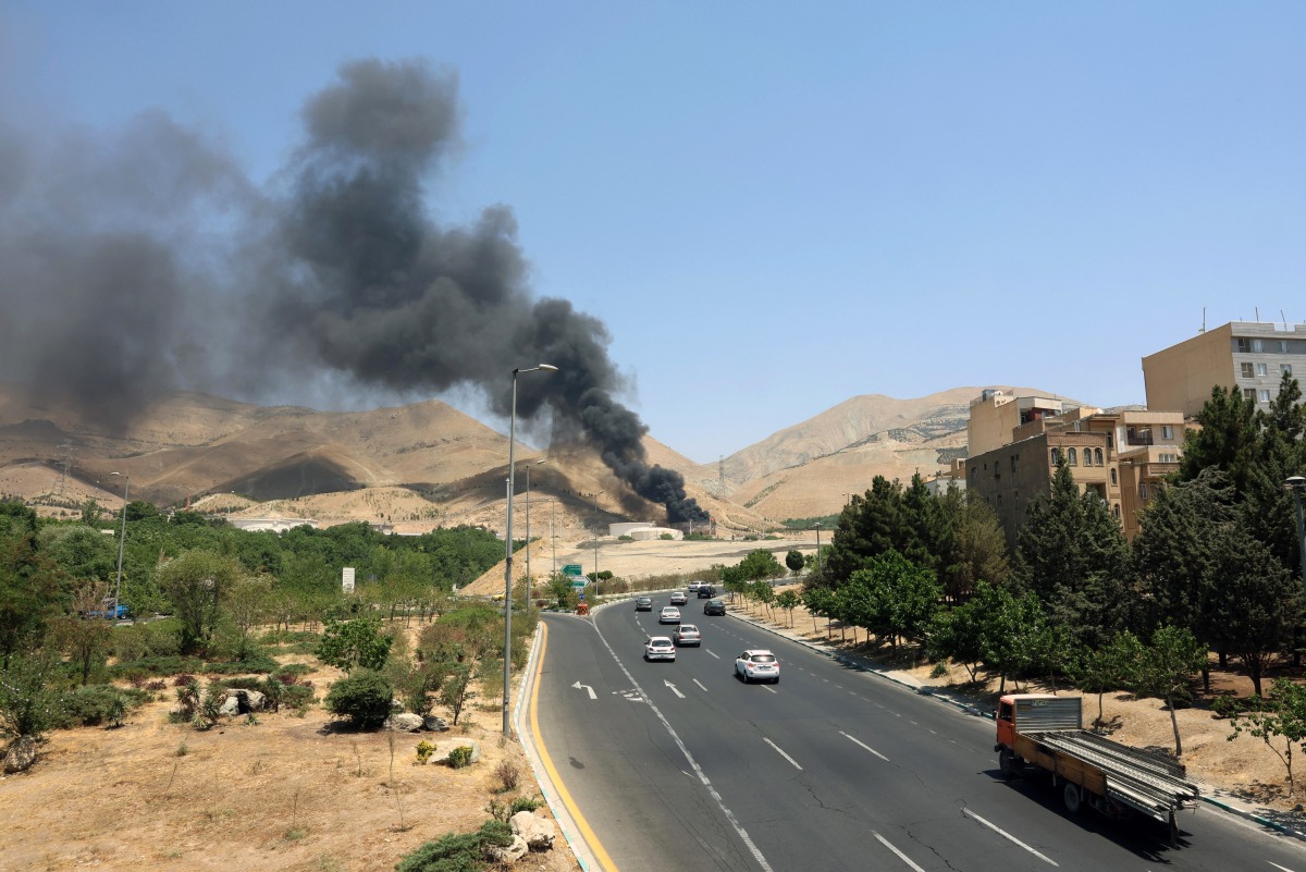 Photo used for representational purposes. Smoke billows for the second day from the Shahran oil depot, northwest of Tehran, on June 16, 2025. Photo by AFP.
