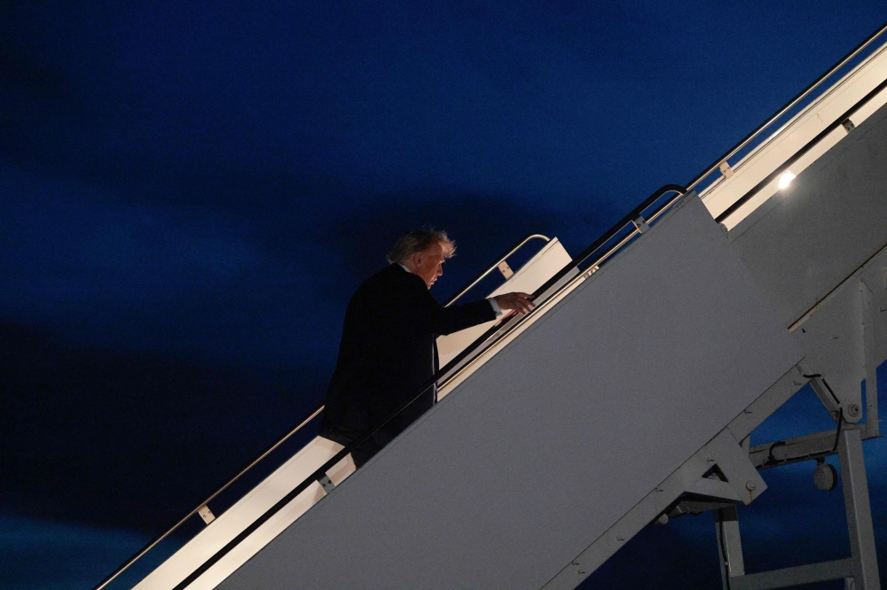 US President Donald Trump boards Air Force One after leaving the G7 Leaders' Summit early on June 16, 2025 in Calgary, Alberta. Chip Somodevilla/Getty Images/AFP 