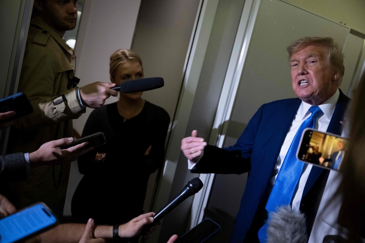 US President Donald Trump speaks to reporters about the G7 Summit aboard Air Force One while travelling back to Washington from Canada on June 16, 2025. (Photo by Brendan Smialowski / AFP)