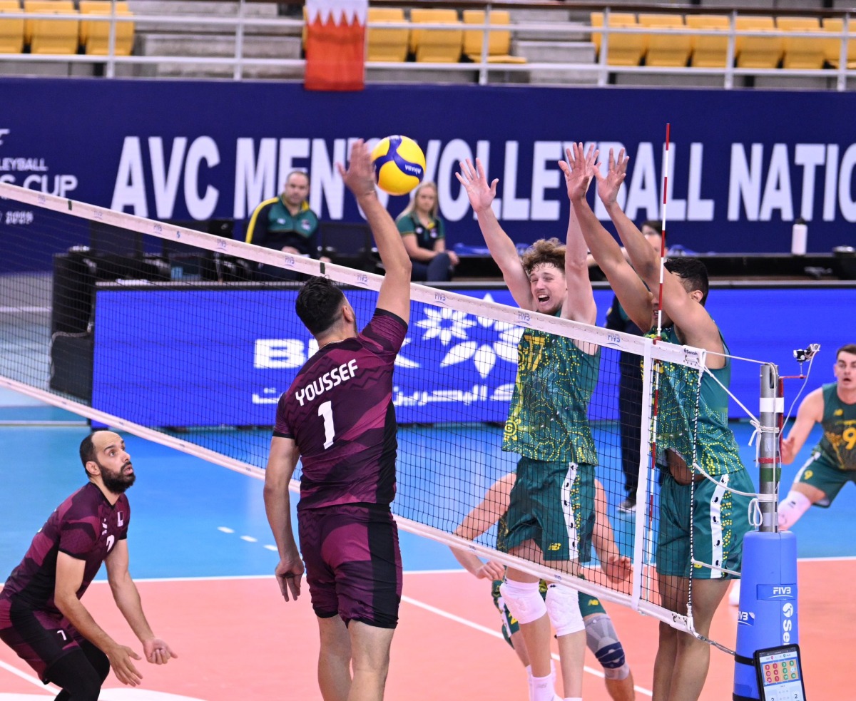 Qatar's Youssef Oughlaf smashes the ball during the match against Australia.