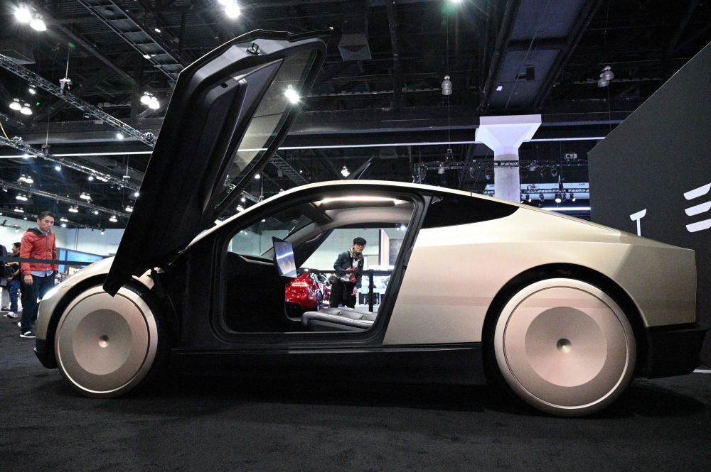 (Files) Tesla's Cybercab robotaxi is displayed during the AutoMobility LA 2024 auto show at the Los Angeles Convention Center in Los Angeles, November 21, 2024. (Photo by Robyn Beck / AFP)
