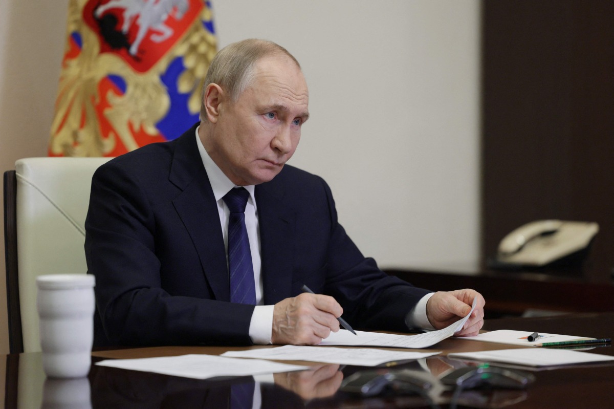 In this pool photograph distributed by the Russian state agency Sputnik, Russia's President Vladimir Putin chairs a meeting on educational and museum complexes via a videoconference at the Novo-Ogaryovo state residence outside Moscow on June 25, 2025. (Photo by Gavriil Grigorov / POOL / AFP)
