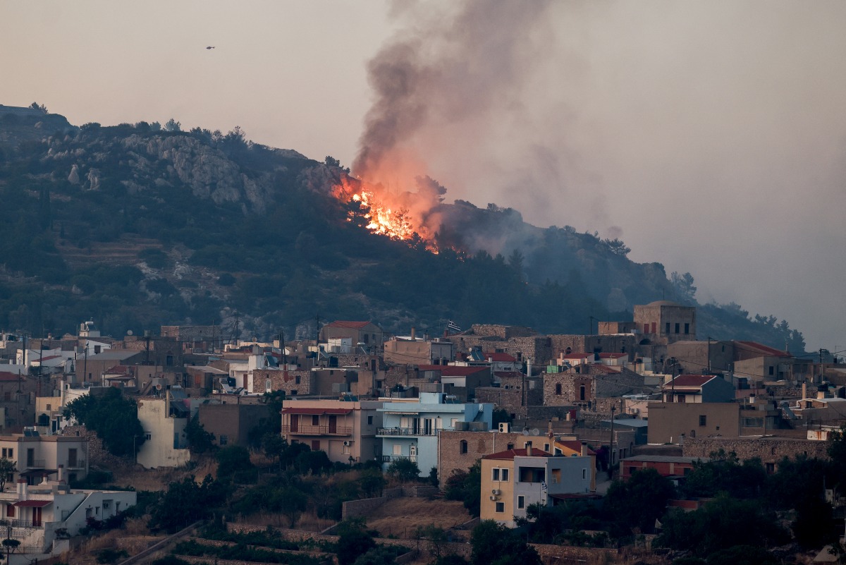 This photograph shows a wildfire moving towards the village of Agios Georgios on the Greek island of Chios on June 23, 2025. Photo by Dimitris Tosidis / AFP