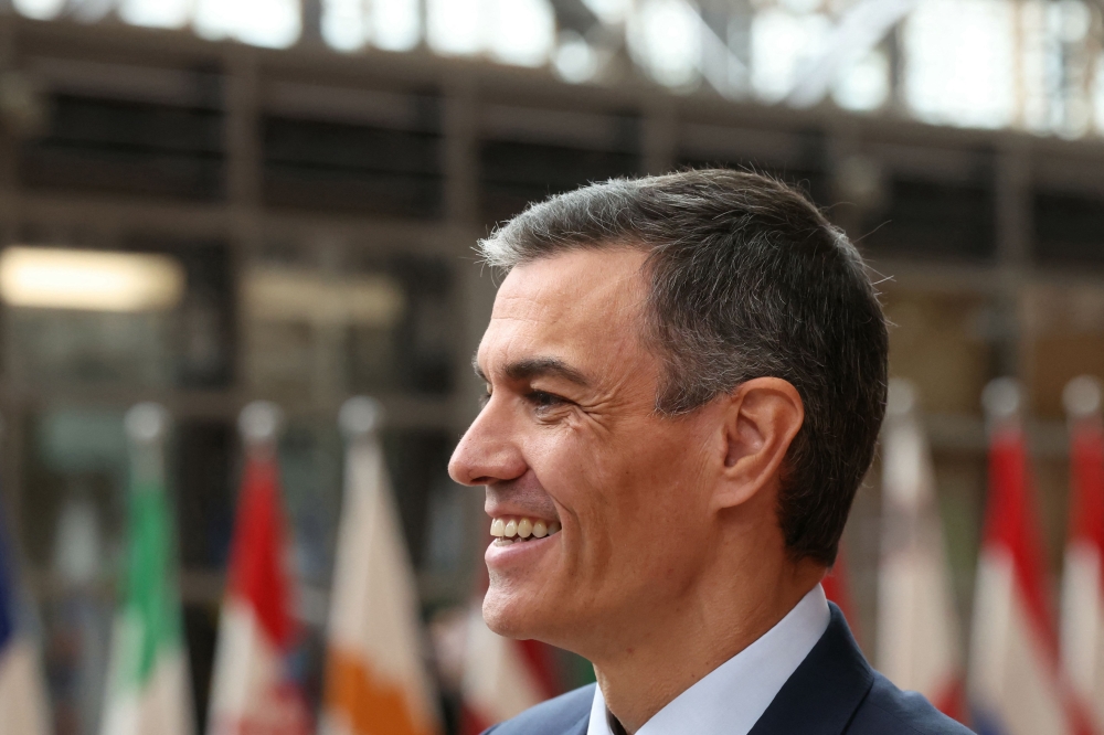 Spain's Prime Minister Pedro Sanchez speaks to the press as he arrives to attend the European Council in Brussels on June 26, 2025. (Photo by Alain Jocard / AFP)